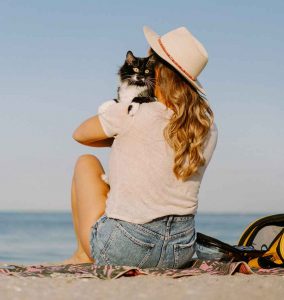 Woman with cat at beach